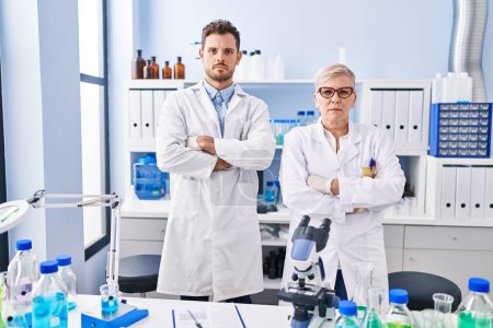 Photo for Mother and son scientist partners standing with arms crossed gesture at laboratory - Royalty Free Image