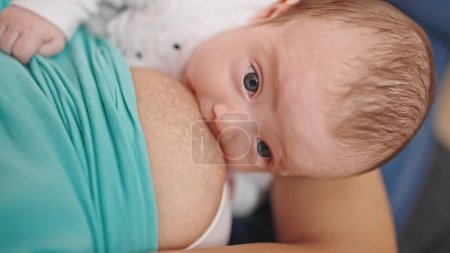 Photo for Caucasian baby girl breastfeeding - Royalty Free Image