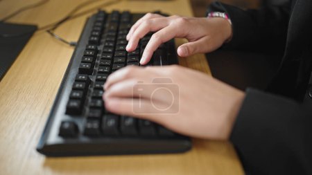 Photo for Young beautiful hispanic woman using computer typing on keyboard at office - Royalty Free Image
