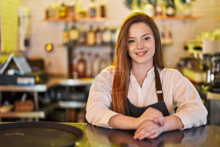 Photo for Young caucasian woman waitress smiling confident leaning on counter at restaurant - Royalty Free Image