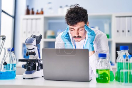 Photo for Young caucasian man scientist stressed working at laboratory - Royalty Free Image