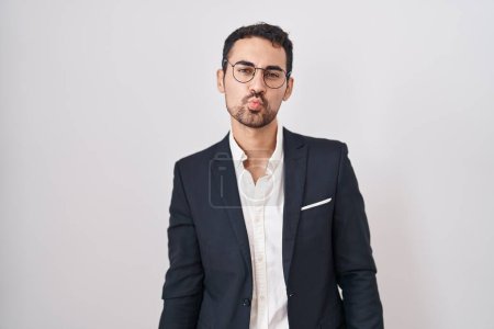 Photo for Handsome business hispanic man standing over white background looking at the camera blowing a kiss on air being lovely and sexy. love expression. - Royalty Free Image
