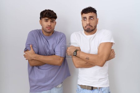 Photo for Homosexual gay couple standing over white background shaking and freezing for winter cold with sad and shock expression on face - Royalty Free Image