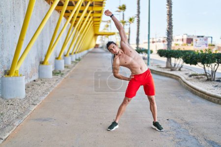Photo for Young man stretching back at street - Royalty Free Image