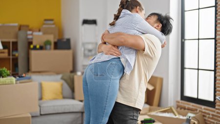 Photo for Man and woman couple smiling confident hugging each other at new home - Royalty Free Image