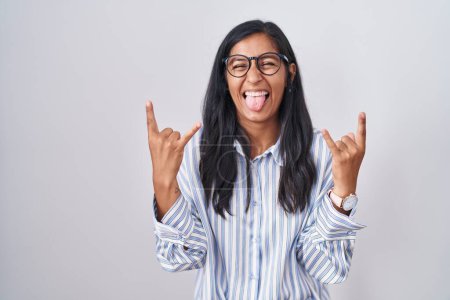 Photo for Young hispanic woman wearing glasses shouting with crazy expression doing rock symbol with hands up. music star. heavy music concept. - Royalty Free Image