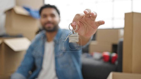 Foto de Hombre afroamericano sonriendo confiado sosteniendo nuevas llaves de la casa en nuevo hogar - Imagen libre de derechos