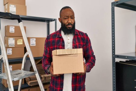 Photo for African american man working at small business ecommerce skeptic and nervous, frowning upset because of problem. negative person. - Royalty Free Image
