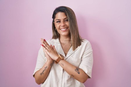 Photo for Blonde woman standing over pink background clapping and applauding happy and joyful, smiling proud hands together - Royalty Free Image