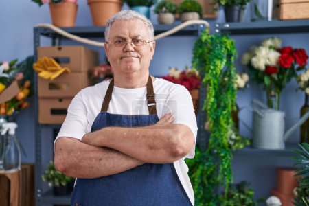 Photo for Middle age grey-haired man florist smiling confident standing with arms crossed gesture at florist - Royalty Free Image
