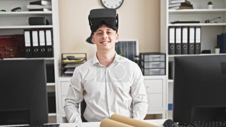 Photo for Young hispanic man architect wearing virtual reality glasses smiling at office - Royalty Free Image