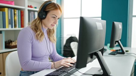 Photo for Young beautiful hispanic woman student using computer wearing headphones at library university - Royalty Free Image
