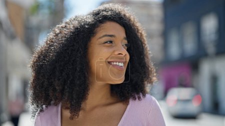 Photo for African american woman smiling confident looking to the side at street - Royalty Free Image