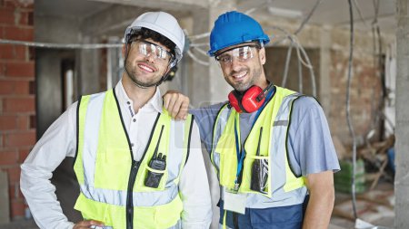 Photo for Two men builders smiling confident standing at construction site - Royalty Free Image