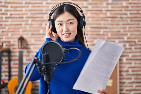 Téléchargez les photos : Femme artiste chinoise chantant chanson au studio de musique - en image libre de droit