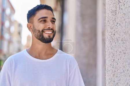 Photo for Young arab man smiling confident looking to the side at street - Royalty Free Image