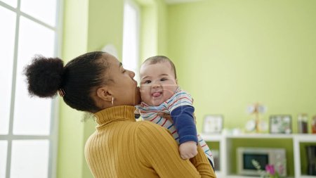 Photo for Mother and son kissing at dinning room - Royalty Free Image