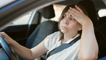 Photo for Middle age hispanic woman stressed driving car at street - Royalty Free Image