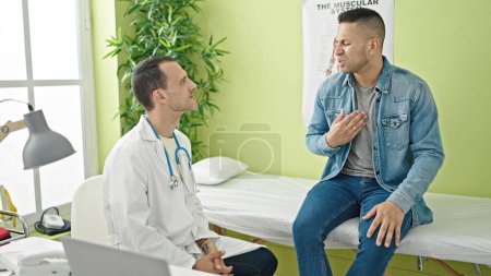Foto de Dos hombres doctor y paciente hablando teniendo consulta médica en la clínica - Imagen libre de derechos
