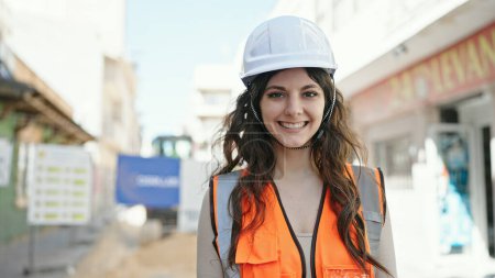 Photo for Young beautiful hispanic woman builder smiling confident standing at street - Royalty Free Image