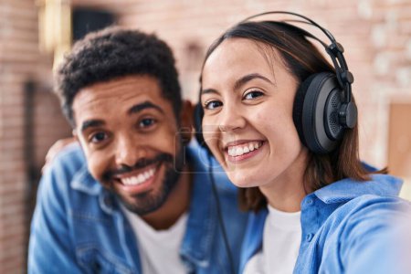 Photo for Man and woman musicians listening to music make selfie by camera at music studio - Royalty Free Image