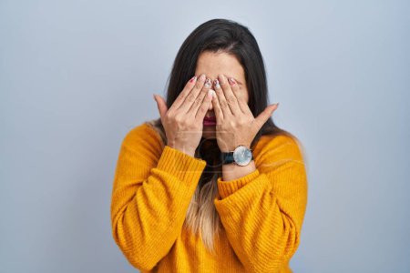 Photo for Young hispanic woman standing over isolated background rubbing eyes for fatigue and headache, sleepy and tired expression. vision problem - Royalty Free Image