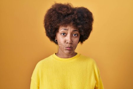 Photo for Young african american woman standing over yellow background depressed and worry for distress, crying angry and afraid. sad expression. - Royalty Free Image