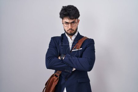 Photo for Hispanic man with beard wearing business clothes skeptic and nervous, disapproving expression on face with crossed arms. negative person. - Royalty Free Image