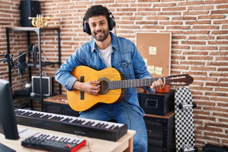 Photo for Young arab man musician playing classical guitar at music studio - Royalty Free Image