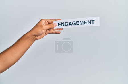 Photo for Hand of caucasian man holding paper with engagement word over isolated white background - Royalty Free Image