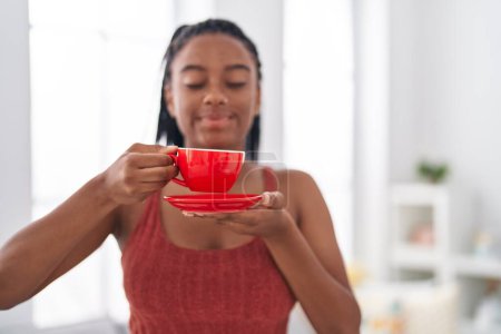 Photo for African american woman smiling confident drinking coffee at home - Royalty Free Image
