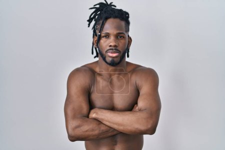 Photo for African man with dreadlocks standing shirtless over isolated background skeptic and nervous, disapproving expression on face with crossed arms. negative person. - Royalty Free Image
