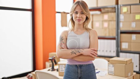 Photo for Young blonde woman ecommerce business worker standing with arms crossed gesture smiling at office - Royalty Free Image