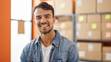 Photo for Young hispanic man ecommerce business worker smiling confident at office - Royalty Free Image