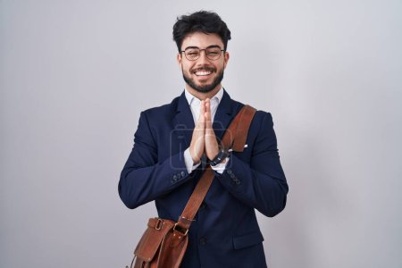 Photo for Hispanic man with beard wearing business clothes praying with hands together asking for forgiveness smiling confident. - Royalty Free Image