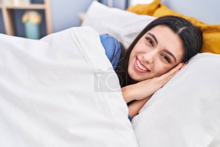 Photo for Young beautiful hispanic woman smiling confident lying on bed at bedroom - Royalty Free Image