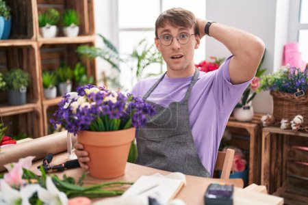 Photo for Caucasian blond man working at florist shop crazy and scared with hands on head, afraid and surprised of shock with open mouth - Royalty Free Image
