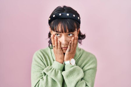 Photo for Young beautiful woman standing over pink background tired hands covering face, depression and sadness, upset and irritated for problem - Royalty Free Image