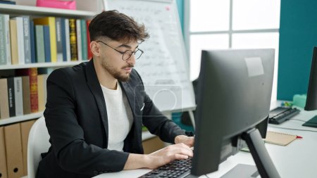 Photo for Young arab man student using computer studying at university classroom - Royalty Free Image