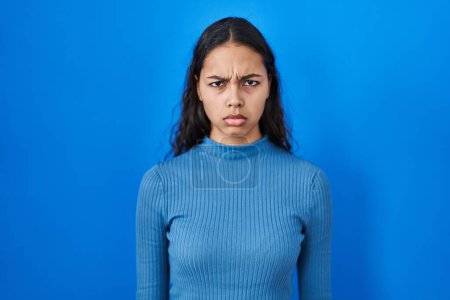 Photo for Young brazilian woman standing over blue isolated background skeptic and nervous, frowning upset because of problem. negative person. - Royalty Free Image