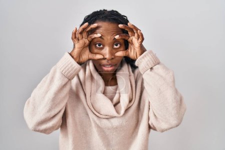 Photo for African woman standing over white background trying to open eyes with fingers, sleepy and tired for morning fatigue - Royalty Free Image