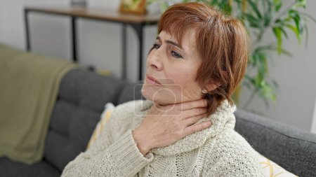 Photo for Mature hispanic woman with sore throat at home - Royalty Free Image