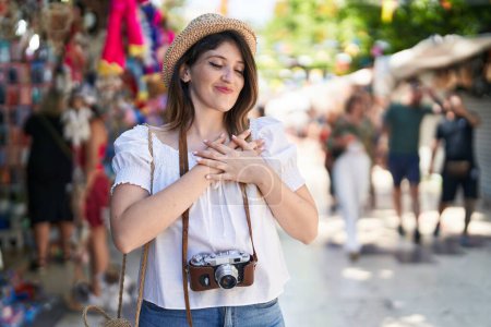 Photo for Young brunette woman on summer vacation smiling with hands on chest, eyes closed with grateful gesture on face. health concept. - Royalty Free Image