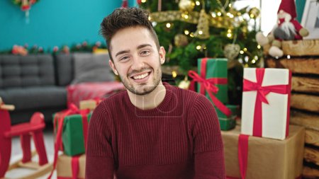 Photo for Young hispanic man celebrating christmas smiling at home - Royalty Free Image
