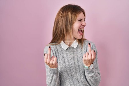 Photo for Beautiful woman standing over pink background showing middle finger doing fuck you bad expression, provocation and rude attitude. screaming excited - Royalty Free Image
