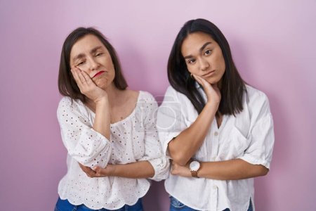 Photo for Hispanic mother and daughter together thinking looking tired and bored with depression problems with crossed arms. - Royalty Free Image