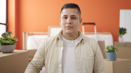 Photo for Young hispanic man standing with relaxed expression at new home - Royalty Free Image
