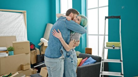 Photo for Man and woman couple hugging each other smiling at new home - Royalty Free Image