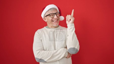 Photo for Middle age grey-haired man wearing christmas hat with idea expression over isolated red background - Royalty Free Image