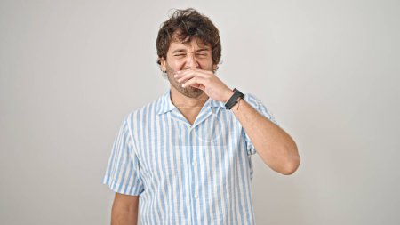 Photo for Young hispanic man sneezing over isolated white background - Royalty Free Image